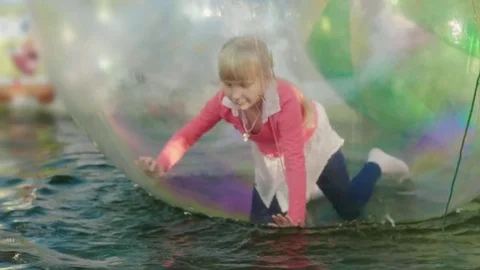 Have fun in the amusement park. Inside the transparent ball the girl runs on all Stock Footage 80113645