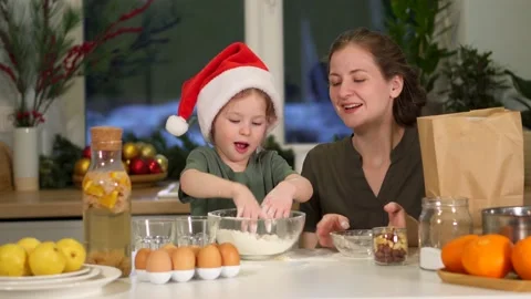 Have fun in kitchen, clap hands with flour on Christmas Eve. Splashes flour fly Video stock 159768770