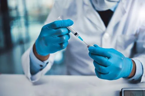 Have to make sure its inserted properly. an unrecognizable scientist working in Stock Photos
