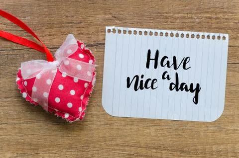 Have a nice day message with handmade red heart on wooden background. Top view Stock Photos