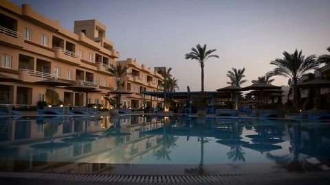 Have a nice evening by the pool at sunset Stock Footage 129028047