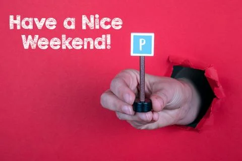 Have a Nice Weekend. Parking road sign in a woman's hand Stock Photos