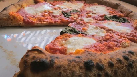 Having a Bite from a slice of the Pizza Mozzarella while sliding to the centre. Stock Footage 87784307