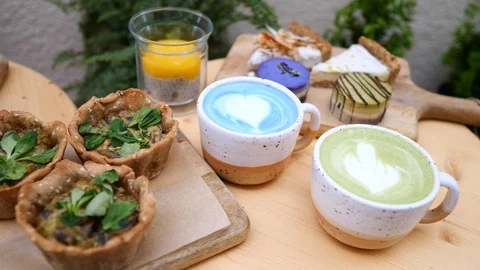 Having Breakfast With Matcha Green Tea Latte, Blue Matcha Latte And Vegan Food. 動画素材 111761920