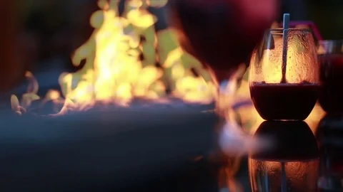 Having a drink by the fire, video Stock Footage 76408193