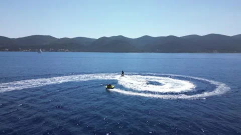 Having fun doing tubbing behind jetski Stock Footage 216912958