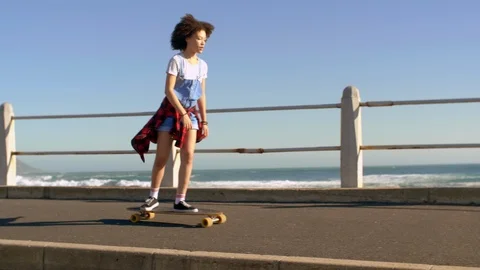 Having fun longboarding by the ocean Stock Footage 118599585