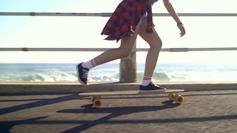 Having fun longboarding by the ocean Stock Footage 118602586
