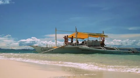 Having fun on outrigger boat on white sand beach Video stock 67600176