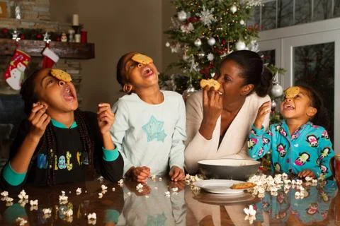 Having fun while trying to eat a cookie off of your head. Foto stock