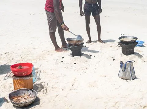 Having joy on beach sand making food Stock Photos