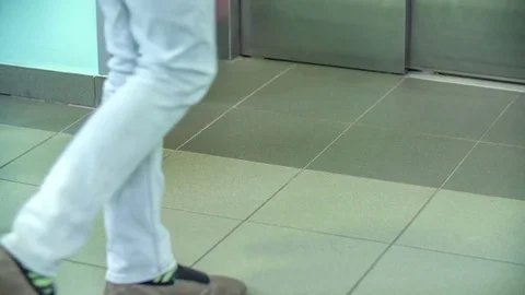 Having a leg in plaster and walking into the elevator Stock Footage 78540361