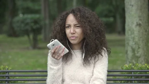 Having a phone call using smartphone and earphone Stock-Footage 73218231