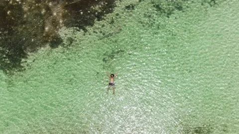 Having a relaxing bath in an unspoiled Caribbean beach Stock Footage 156939791