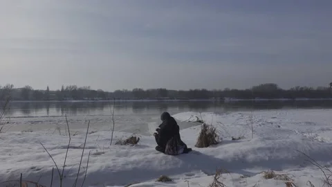 Having a rest by the riverbank on a winter day 스톡 동영상 149218010