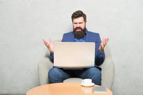 Having some problems at work. Hipster drinking coffee and working on computer Stock Photos