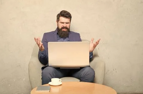 Having some problems at work. Hipster drinking coffee and working on computer Stock Photos