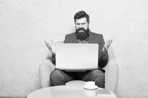 Having some problems at work. Hipster drinking coffee and working on computer Stock Photos