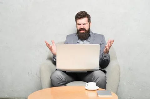 Having some problems at work. Hipster drinking coffee and working on computer Stock Photos