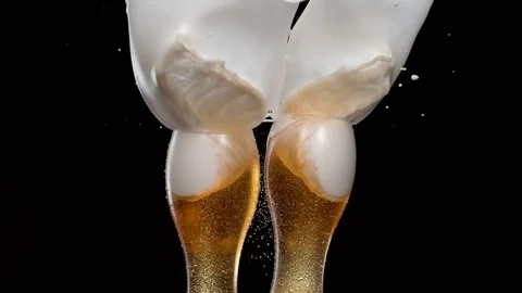 Having a toast with two glasses of beer and spilling. Slow Motion. Stock Footage 72851865