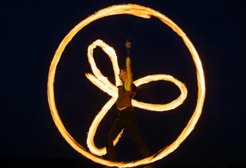 Having tricks for celebration. Man perform fire tricks in darkness. Fire Stock Photos