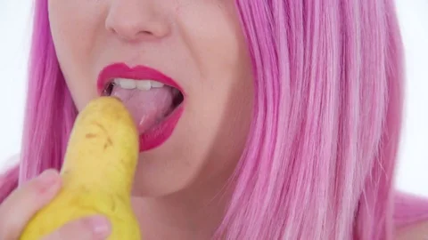 Having a yellow pear for her snack Stock Footage 83726118