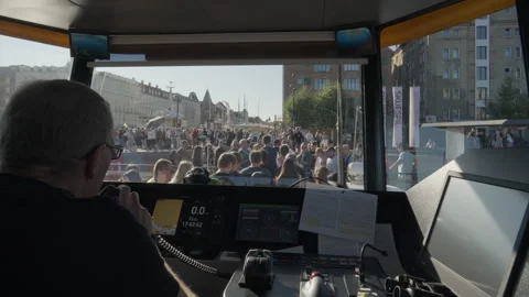 Havnebus captain gestures to crew and speaks into radio during vessel docking Stock Footage 344866351