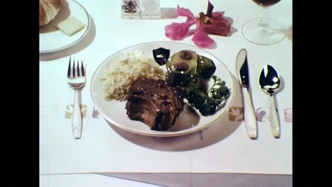 HAWAII - 1970s - First class passengers eat entrees such as lamb chops and Stock Footage 304340744