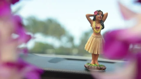 Hawaii travel car Hula doll dancing on dashboard and lei during road trip