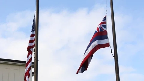 The Hawaiian flag waving in the wind next to the American flag Stock Footage 99752659