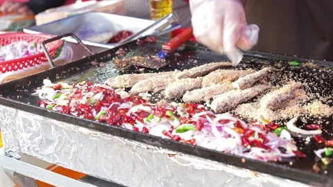 Hawker can seen preparing ikan pekasam goreng Stock Footage 238007853