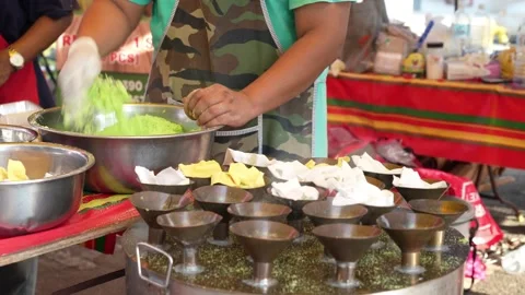Hawker can seen preparing Putu Piring during Ramadan bazaar 動画素材 237927174