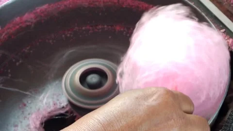 A hawker making sweet cotton candy. Stock Footage 338240039