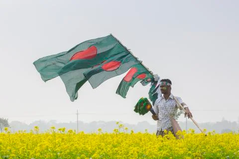 A Hawker sells Bangladeshi national flags Stock Photos
