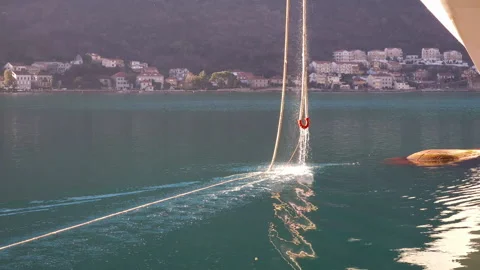 Hawser rope being pulled up into a docked ship through cat hole on the bow Stock Footage 231199514