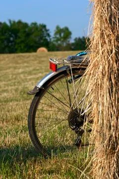 Hay bale in a field with bicycle. Stock Photos