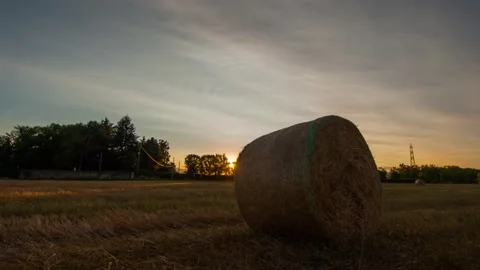 Hay bale in a field at sunset timelapse Stock Footage 160546603