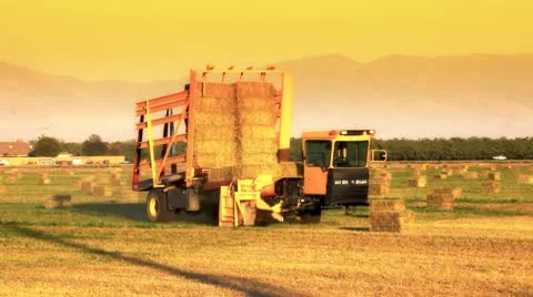 hay bale machine loader on farm | Stock Video | Pond5