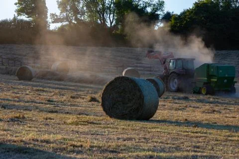 Hay Harvest June 2020 UK red tractor Stock Photos