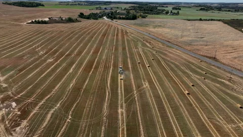 Hay making in field. Tractor with round baler. 库存影片 218391093