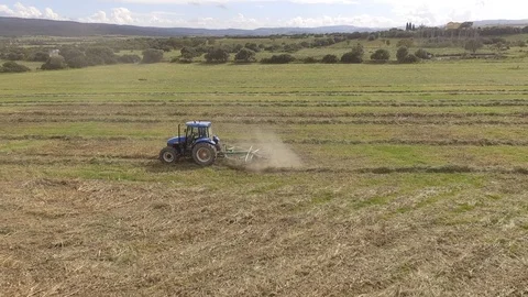 Hay rake tractor turning the hay Stock Footage 107931349
