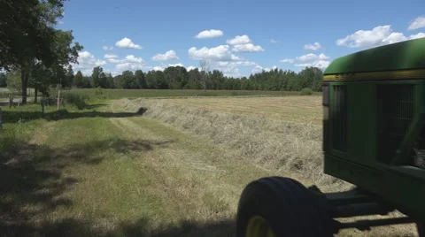 Haying square bales with a tractor and trailer. Stock Footage 61544835