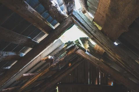 The hayloft in the barn. Sunlight breaks through the leaky roof. Village vibe Stock Photos