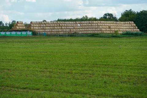 A haystack in a field against the background of beautiful clouds after the ra Stock Photos