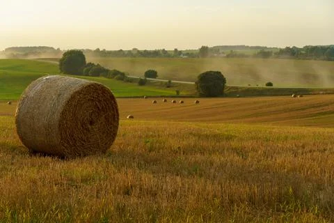 A haystack in a field against the background of beautiful clouds after the ra Stock Photos