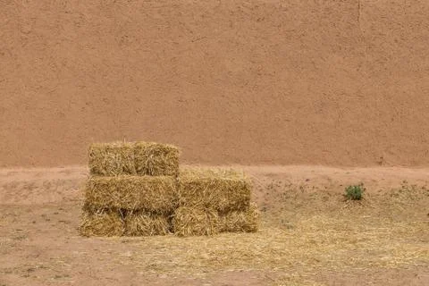 The haystack in front of dried  wall made of soil and straw as afican traditi Stock Photos