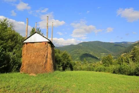 Haystack on  green meadow in  mountains Stock Photos