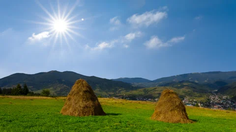 Haystack on green pasture in mountain time lapse scene Stock-Footage 248034209