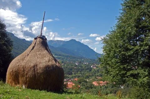 Haystack in mountains, blue sky, green nature Stock Photos