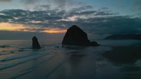 Haystack Rock at Cannon Beach During Low Tide at Sunset, Aerial Stock Footage 335965268